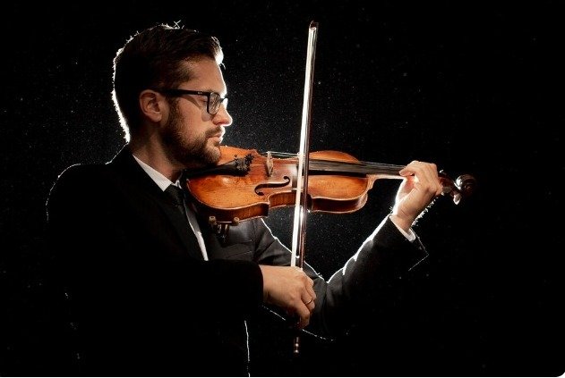 Male Pupil With Teacher Playing Drums In Music Lesson